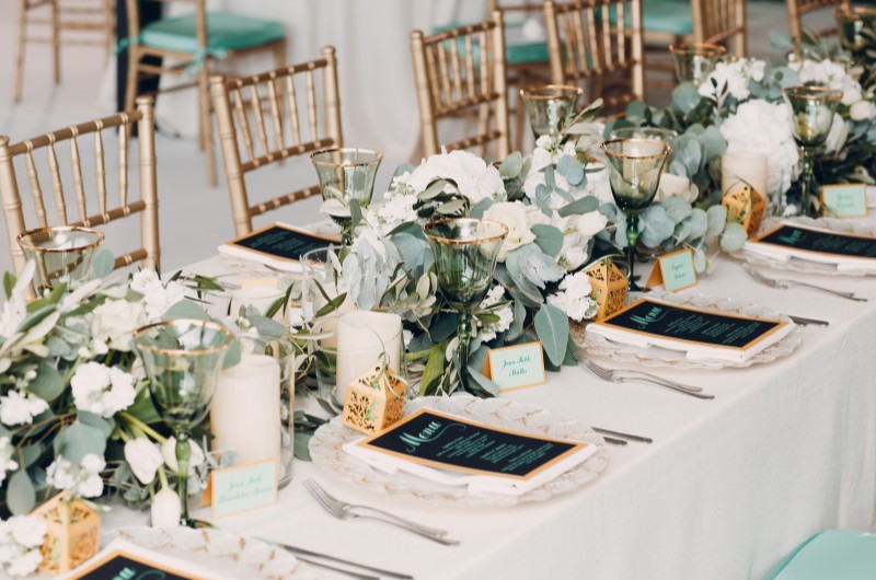 Como planejar um casamento: como começar o planejamento | Foto de uma mesa de casamento decorada com flores, mesa posta e cardápio | Economia e renda extra | Eu Dou Conta 