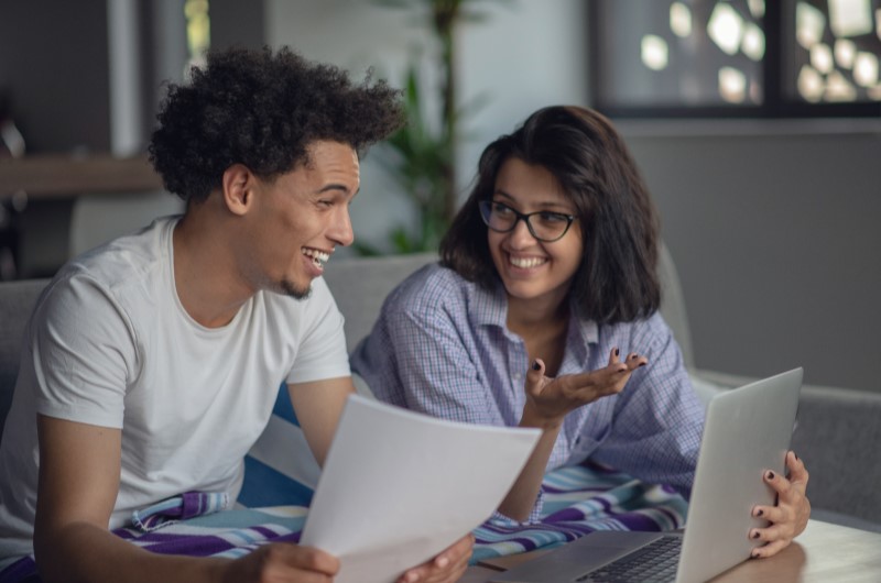 Delimite prazos | Foto de um casal conversando em frente ao notebook | Economia e renda extra | Eu Dou Conta 