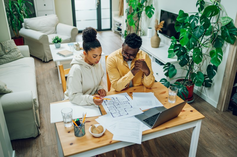 Dicas na hora de escolher seus móveis modulados | Casal discutindo planta baixa em uma mesa com notebook | Casa e Decoração | Blog da Tenda 