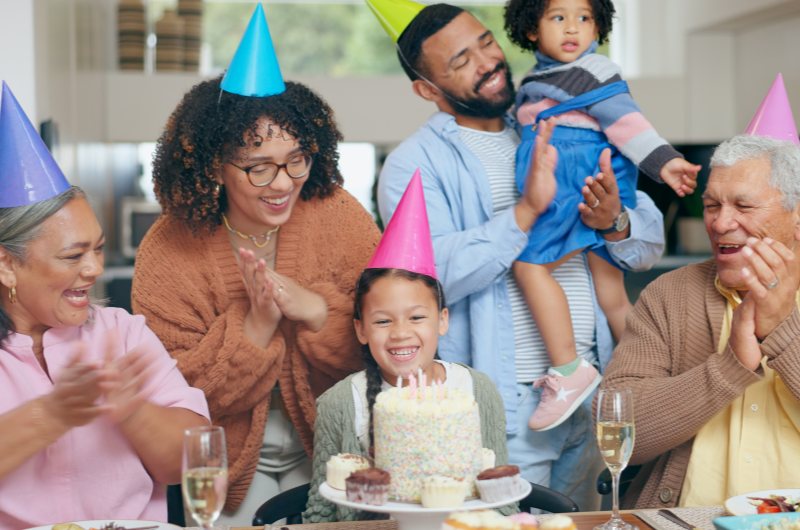 Como fazer uma festa de aniversário econômica? | Foto de uma família feliz comemorando um aniversário em casa | Economia e renda extra | Eu Dou Conta